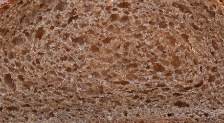 A close-up shot of the interior texture and structure of whole wheat bread, showcasing its soft texture with visible cross-hatching for mouthwatering detail