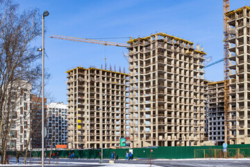 Construction of the third stage of a new residential complex 'in the forest'. Work construction cranes, is the construction of walls of buildings. Moscow, Russia