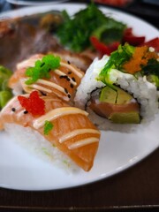Delicious nigiri and maki sushi displayed on white plate in prague restaurant all you can eat