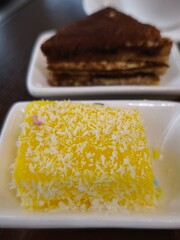 Delicious yellow dessert with coconut flakes and tiramisu in prague all you can eat