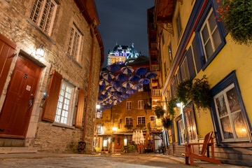 Quebec, Canada - October 18 2021 : Umbrella Alley. Quebec City Old Town street view in autumn night.