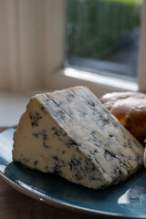 Cheese collection, English cow milk semi-soft, crumbly old stilton blue cheese and baked scones buns
