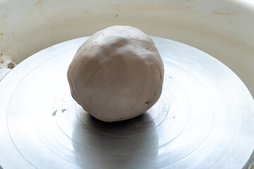 Making of mud pot on potters wheel during workshop in art ceramic atelier in Poland