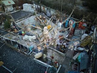 Scary garden with toys hanging from trees, featuring a collection of plush toys.