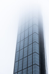 Modern skyscraper in Warsaw at foggy day