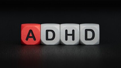 Concept of ADHD Attention Deficit Hyperactivity Disorder word on Wooden cube.close up of wooden elements,Business Concept.3D rendering on black background.