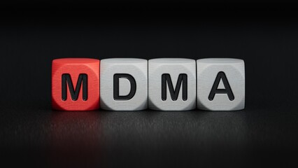 Obraz premium cubes with the word MDMA. Care concept.close up of wooden elements,Business Concept.3D rendering on black background.