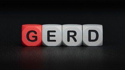 The word GERD is written on wooden cubes. Medical concept.close up of wooden elements,Business Concept.3D rendering on black background.