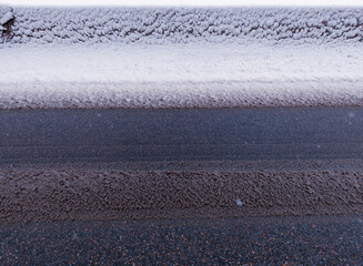 Road fender covered with snow road surface background