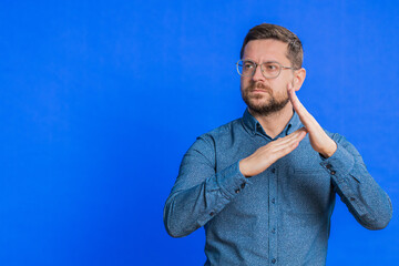 Tired serious upset Caucasian middle-aged man showing time out gesture, limit or stop sign, no...