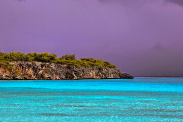 coastline of tropical island curacao in the caribbean with thunder storms in the distance