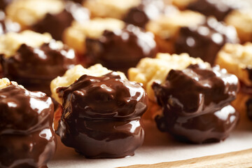 Closeup of homemade Christmas cookies filled with marmalade and dipped in chocolate