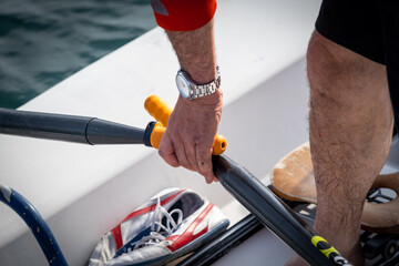 crossed oars in hand