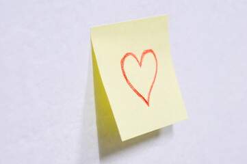 Post it with heart on wall