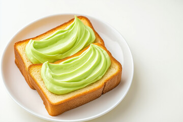 Two slices of bread with pandan custard cream on white plate