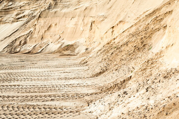 Excavator wheel marks in a sand quarry