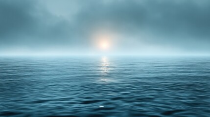 Obraz premium Misty sunrise over calm ocean.
