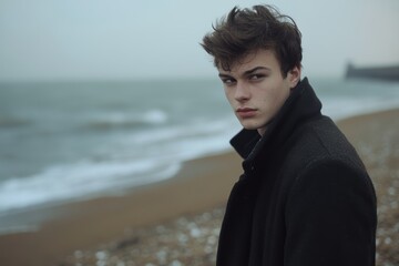 Young Man Stares Into Distance on Foggy Beach Seaside Landscape