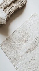 Obraz premium A Minimalist Abstract Art Piece Featuring Textured Paper and Driftwood. A Stunning Composition of Neutral Tones and Natural Elements.