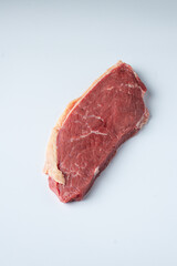 A raw picanha on a white background.