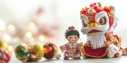 Obraz premium a small child doll sits next to a lion dance doll surrounded by Chinese New Year ornaments on a table. lots of empty space for text. light background blur
