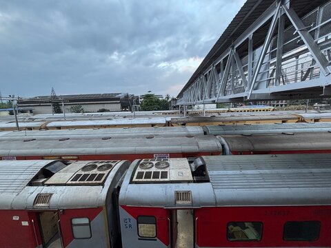 A top-view photo of a busy railway station with multiple trains lined up on parallel tracks, showcasing the dynamic and bustling atmosphere of transportation hubs. Ideal for themes of travel, infrastr