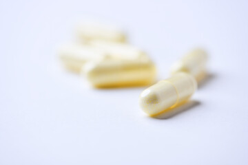 Alpha-lipoic acid capsules. Paper background. Soft focus. Close up. Copy space.