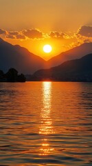 Fototapeta premium Golden Sunset Over Serene Lake with Majestic Mountain Silhouette