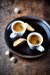 Cantuccini (Italian cookie) and Two Cups Of Coffee on rustic stone background. Copy space.