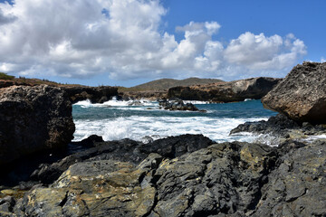 Waves Crashing on to the Black Lava Rock Cove