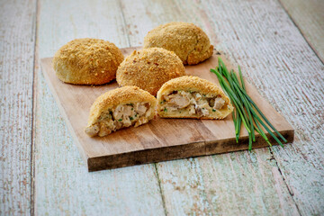 chicken and cream cheese stuffed pizza dough packs served on a cutting board