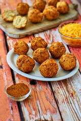 cheddar cheese hushpuppies served with a dipping sauce