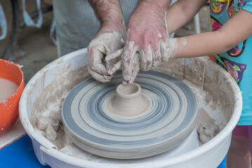 The master teaches young people clay art.