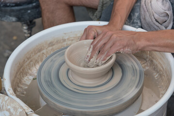 The master teaches young people clay art.