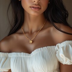 Elegant woman wearing a gold necklace featuring a sun pendant and a white off-shoulder top