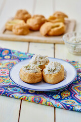 chicken salad puffs on a blue napkin
