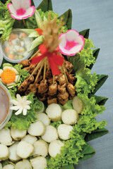 Satay is a popular  Indonesia dish of seasoned, skewered and grilled chicken and meat, served with peanut sauce.