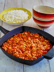 crab gumbo presented in a cast iron skillet