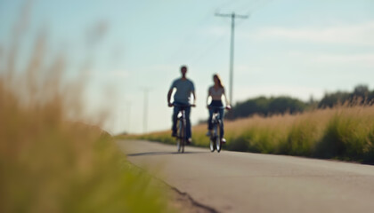 Couple Cycling Along a Country Road on a Sunny Day