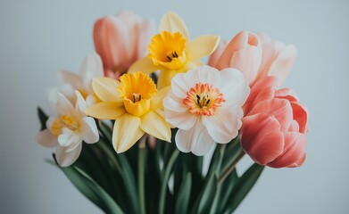 Obraz premium Stunning Bouquet of Spring Blossoms: Daffodils and Tulips in Pastel Hues