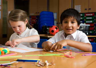 Elementary School: Creative Play. A happy glance from a primary school boy of South Asian heritage...