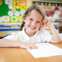 Elementary School: Happy Pupil. A bright, natural smile and eye contact from a young junior school...