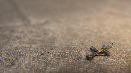 Small Horseshoe Nail Cross on Cement