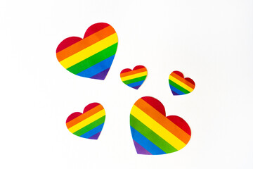 cut out colored paper hearts on white background, transexual colors, lgbt pride concept, big raindow colors heart