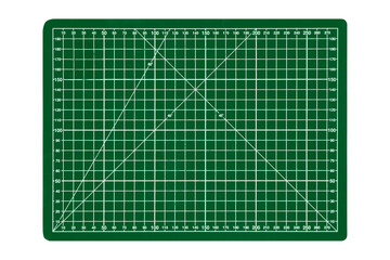 A small green cutting mat with a white grid is isolated.	