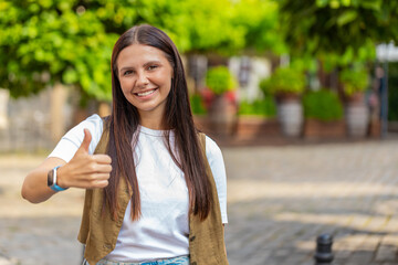 Like. Happy woman raises thumbs up agrees with something or gives positive reply recommends...