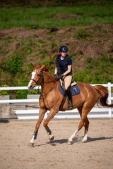 Woman riding a horse on the jumping race
