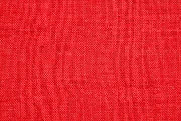 A piece of red linen, macro, top view.