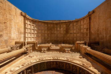 Fototapeta premium View from below of the Renaissance entrance to the church of Santa María in Alarcón, Cuenca, Castilla-La Mancha, Spain, with golden morning light