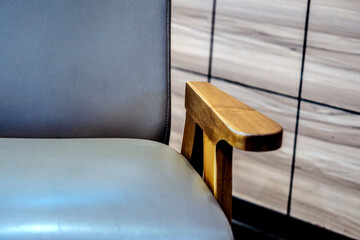 close up wooden armrests on chairs